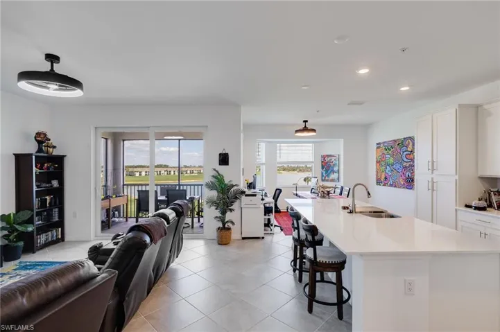 Living room featuring light tile patterned floors and recessed lighting