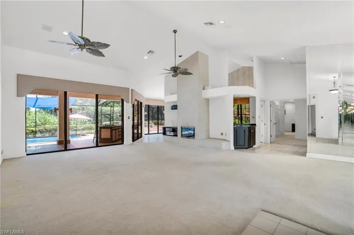 Living room with vaulted ceilings and large windows