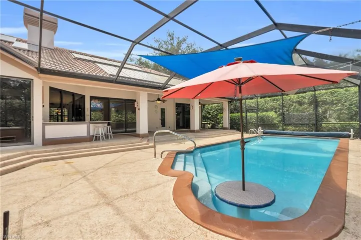 View of swimming pool, lanai, and sunshade