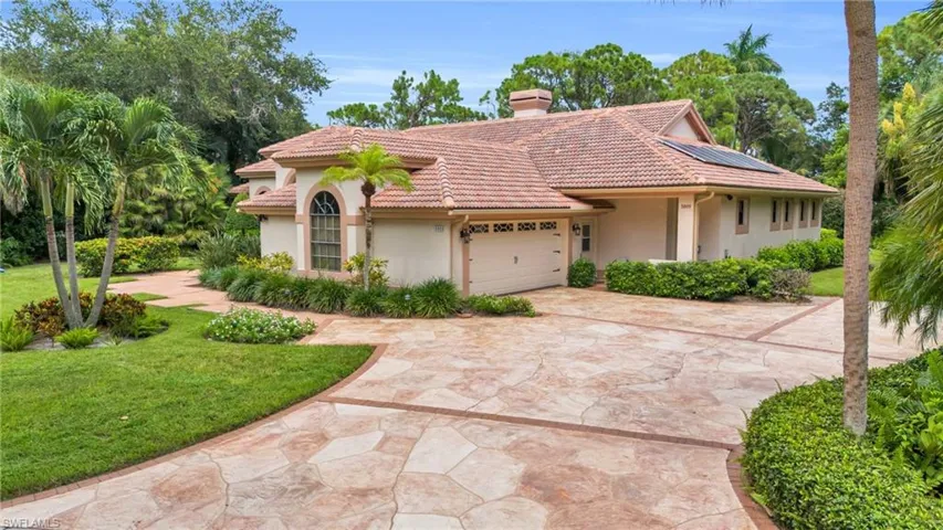 Mediterranean-style home with manicured lawn