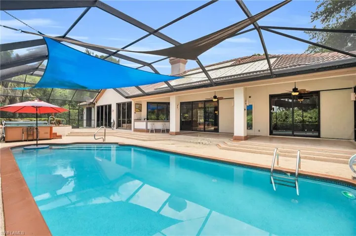View of swimming pool featuring a patio area, and ceiling fan