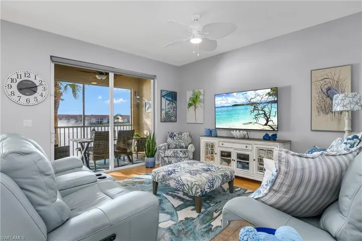 Living area with a ceiling fan and wood finished floors