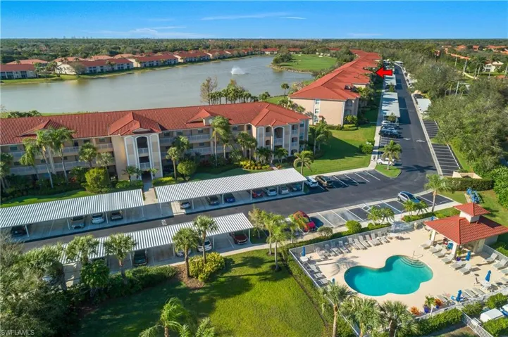 Birds eye view of property featuring a water view and a residential view