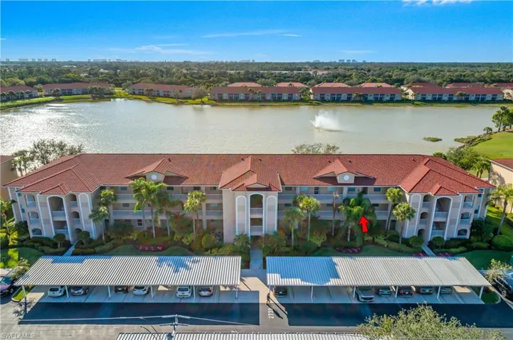 Birds eye view of property with a water view and a residential view