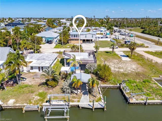 Rear view of property with boat lift and shared cut-in boat slip