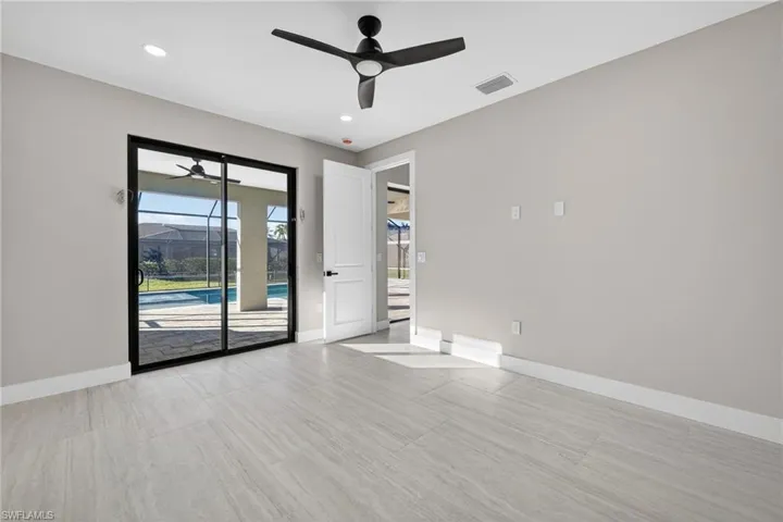 Empty room featuring a sunroom, ceiling fan, and recessed lighting