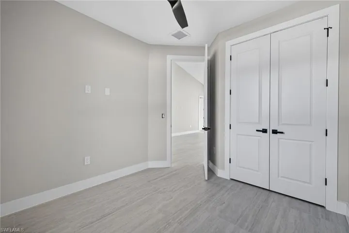 Unfurnished bedroom featuring a ceiling fan and light wood-type flooring