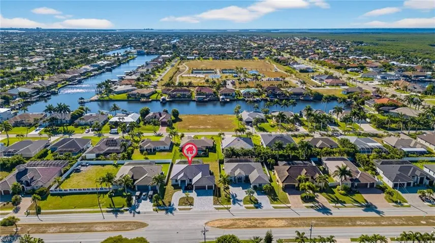 Aerial perspective of suburban area with a nearby body of water