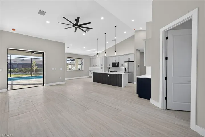 Unfurnished living room featuring a ceiling fan, recessed lighting, and high vaulted ceiling