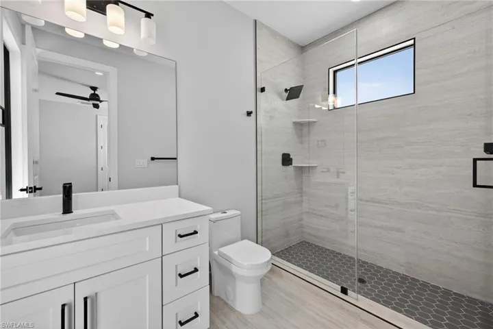 Full bathroom featuring vanity and a stall shower