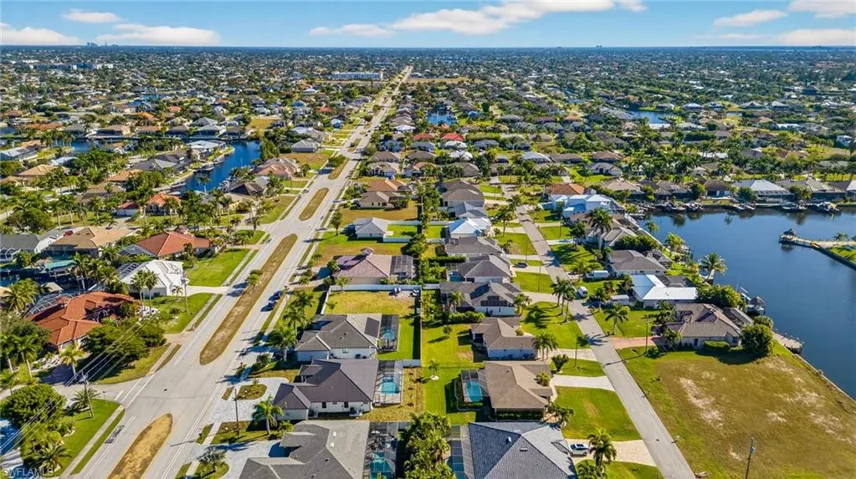 Aerial perspective of suburban area with a nearby body of water