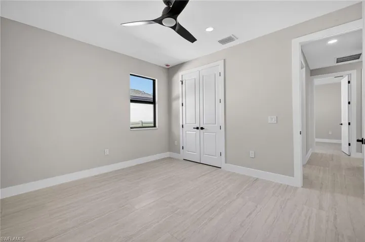 Unfurnished bedroom featuring ceiling fan, a closet, and recessed lighting