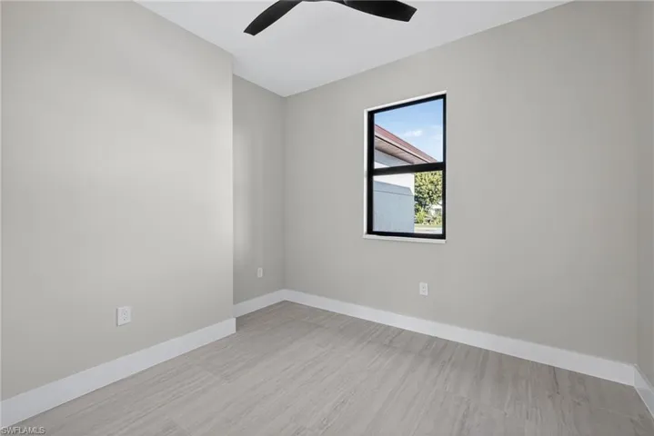 Unfurnished room featuring baseboards and light wood finished floors