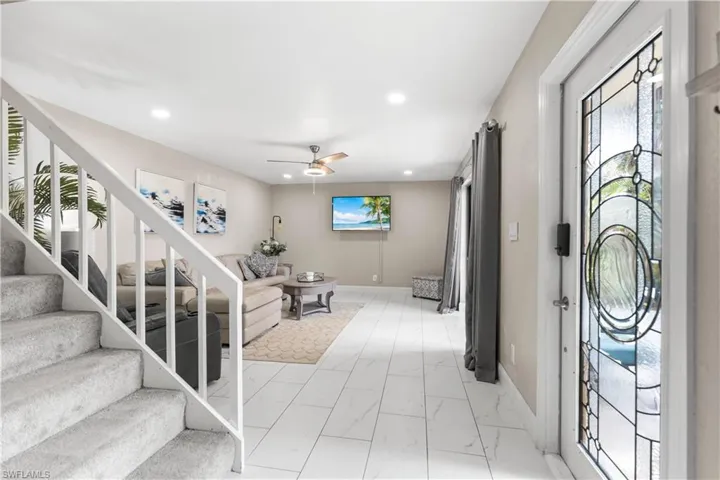 Front entry with beautiful leaded glass door and white large format tile