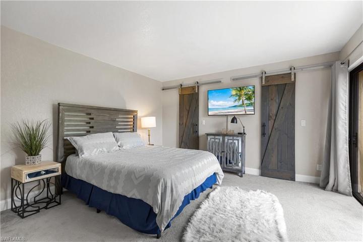 Master suite with barn door style closet doors hiding 2 walk-in closets.