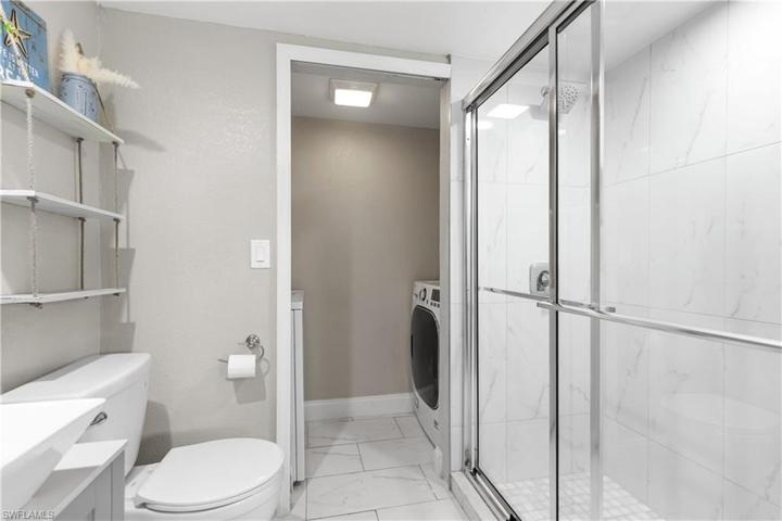 Large format marble shower tile.