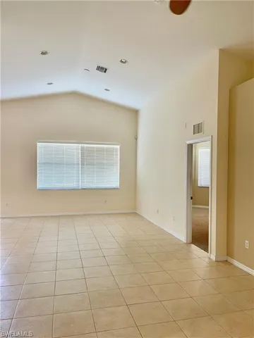 Unfurnished room featuring light tile patterned floors and baseboards