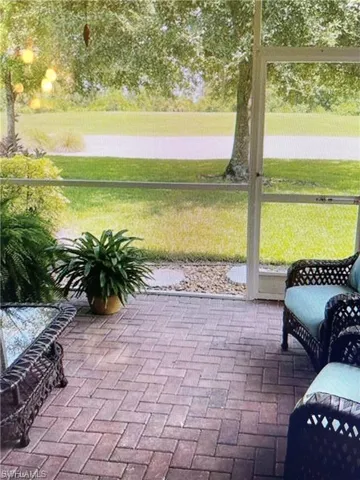 View of property exterior with stucco siding, a yard, a tile roof, and a sunroom