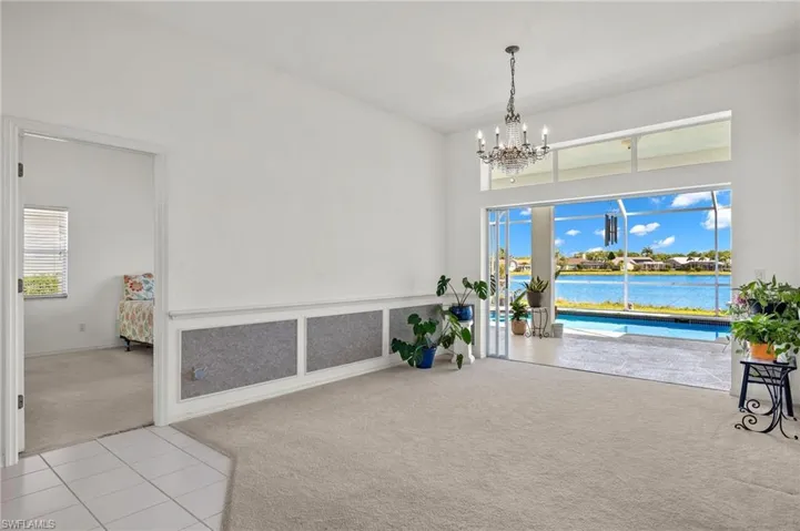 Living area featuring a chandelier, a wealth of natural light, and light tile flooring