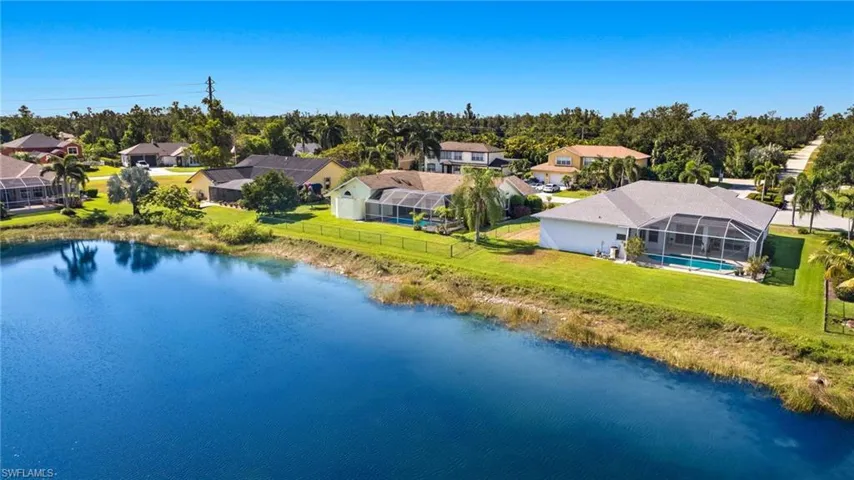Birds eye view of property with a water view