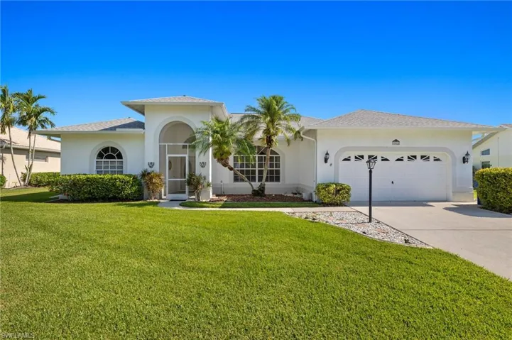 View of front of home featuring a front lawn and a garage