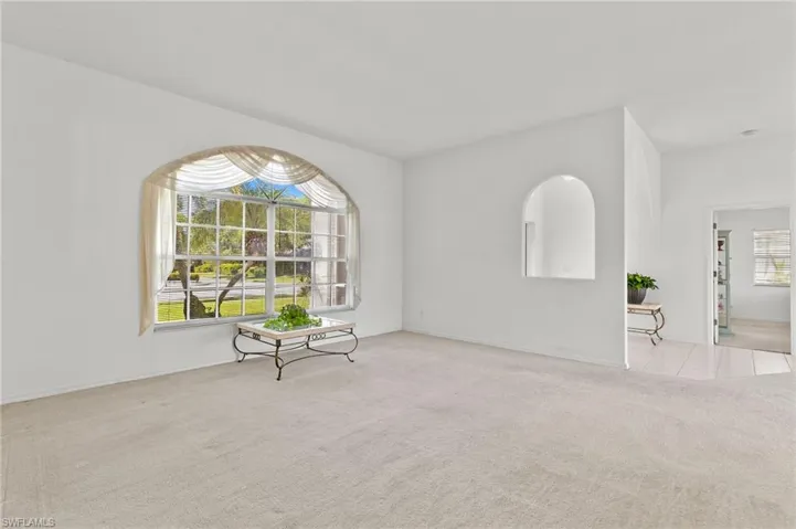 Unfurnished room featuring light colored carpet