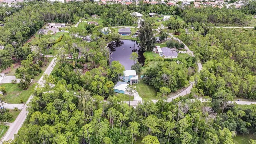 Aerial view of property's location with a large body of water