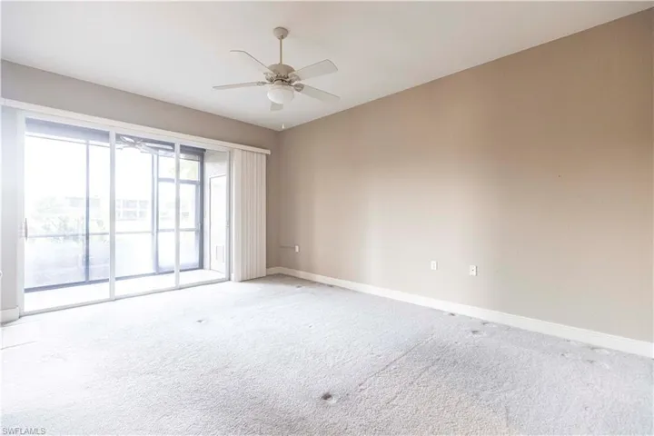 Unfurnished room featuring baseboards, light colored carpet, and a ceiling fan