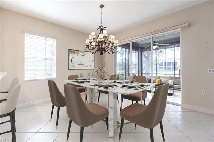 Dining space with light tile patterned flooring and a chandelier