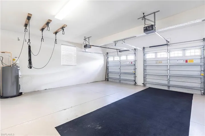Garage with water heater and a garage door opener
