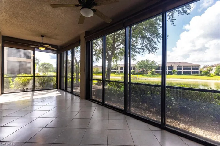 Unfurnished sunroom featuring a ceiling fan and plenty of natural light