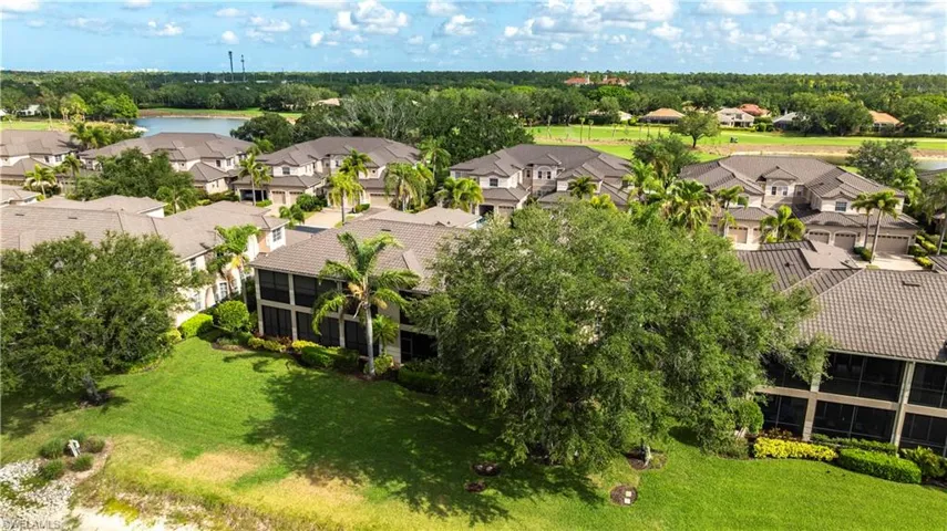 Aerial view of residential area featuring a large body of water