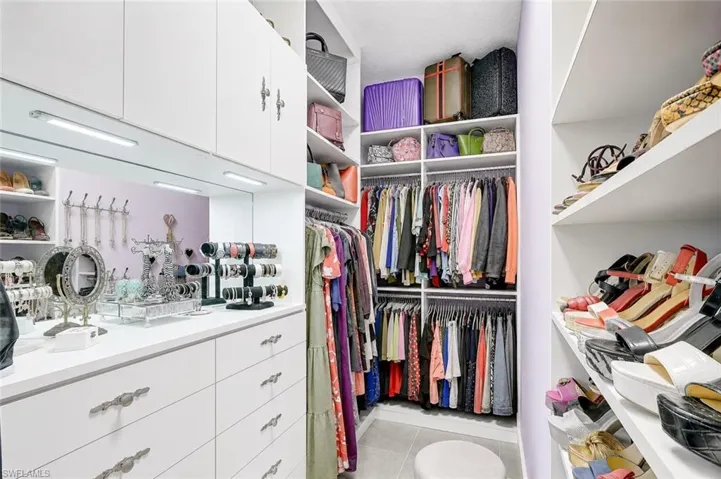One of Two Primary Walk In Closets w Built Ins