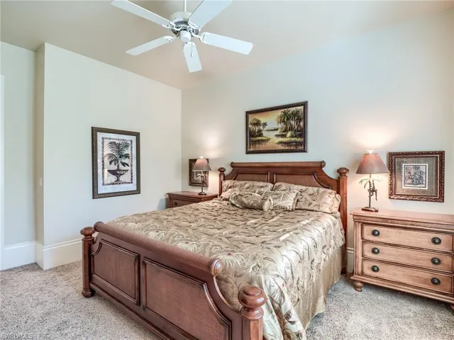 Bedroom featuring light carpet and ceiling fan