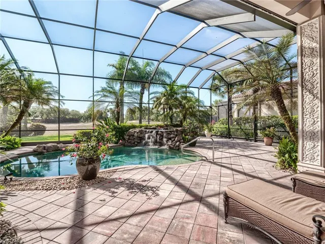 View of pool with pool water feature, a lanai, and a patio
