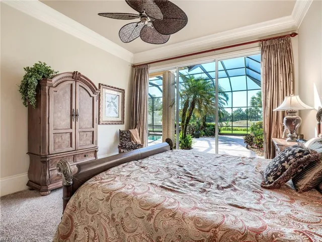Carpeted bedroom featuring ornamental molding, ceiling fan, access to exterior, and multiple windows