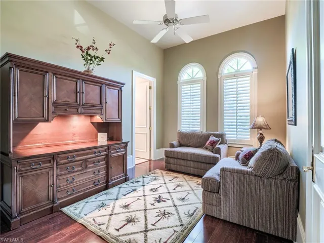 Living room with ceiling fan and dark hardwood / wood-style flooring