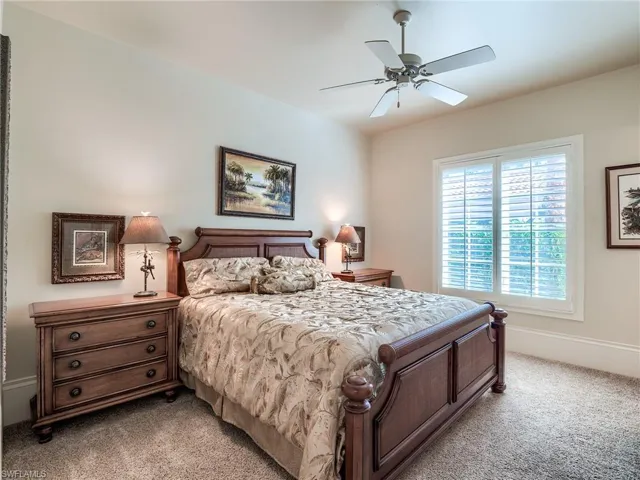 Carpeted bedroom with ceiling fan
