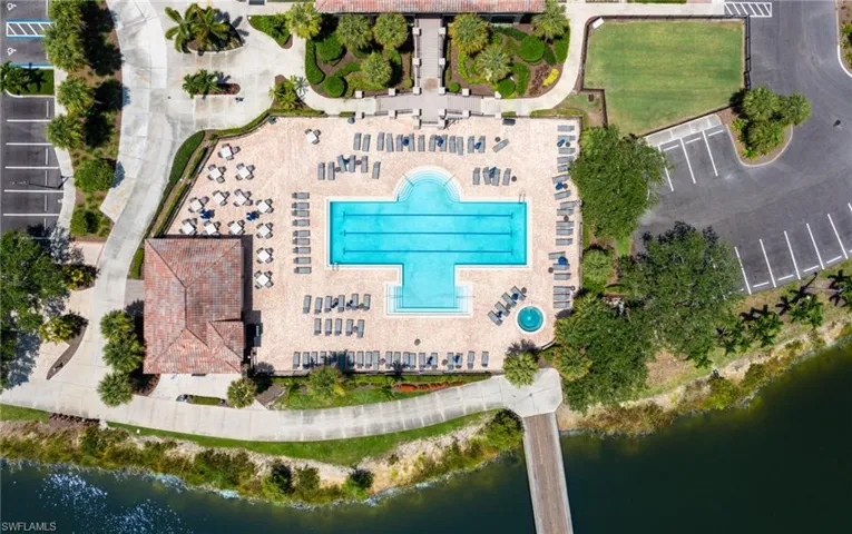 Aerial view of a pool area and a large body of water