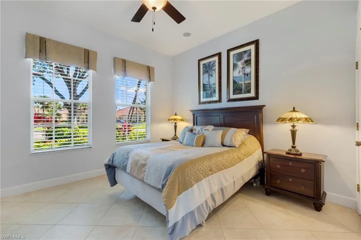 Bedroom with a ceiling fan and light tile patterned floors
