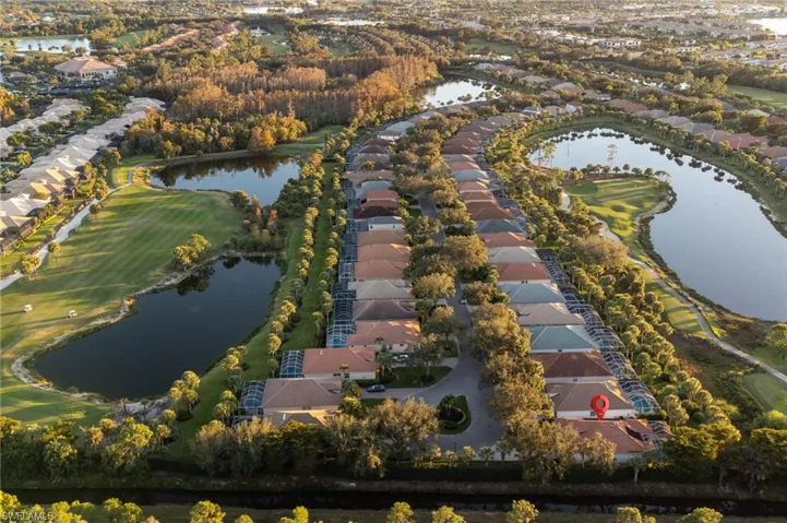 Aerial view of property's location featuring nearby suburban area and a nearby body of water