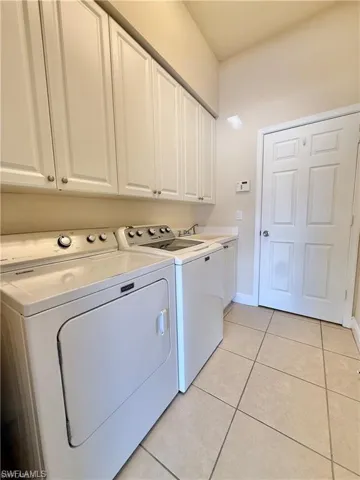 Laundry Room with Utility Sink and Full Size Washer/ Dryer and Ample Cabinetry