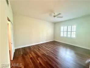 Primary Bedroom with Sunny view of Park like yard and Ceiling Fan