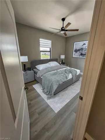 Bedroom featuring dark hardwood / wood-style floors and ceiling fan