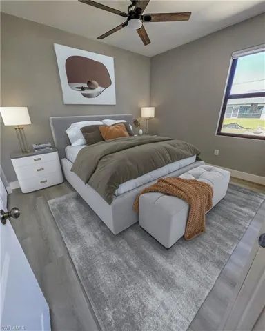 Bedroom featuring ceiling fan and light hardwood / wood-style flooring