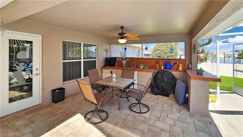 View of patio / terrace featuring a wet bar and ceiling fan