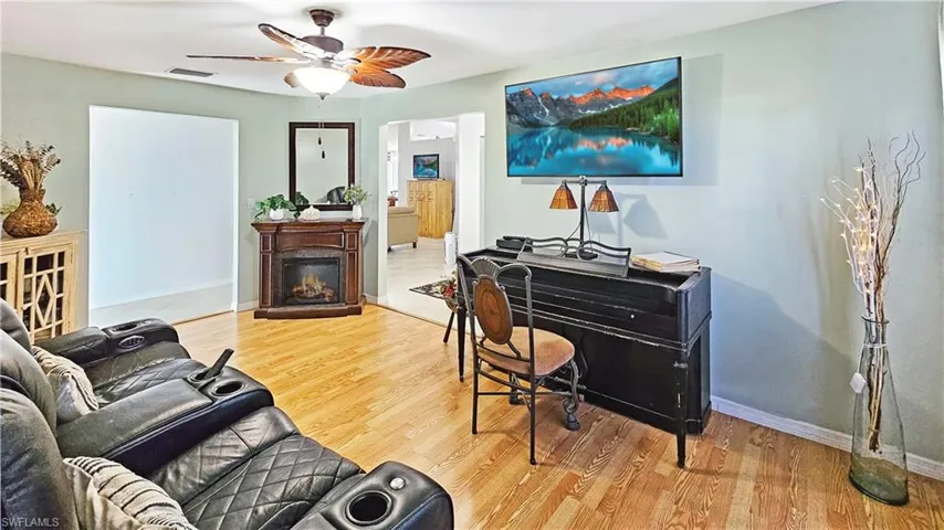 Living room with ceiling fan and wood-type flooring