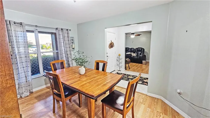 Dining space with light hardwood / wood-style floors and ceiling fan