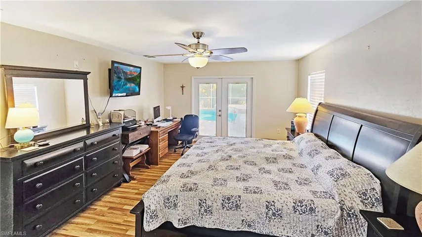 Bedroom featuring french doors, ceiling fan, hardwood / wood-style flooring, and access to outside