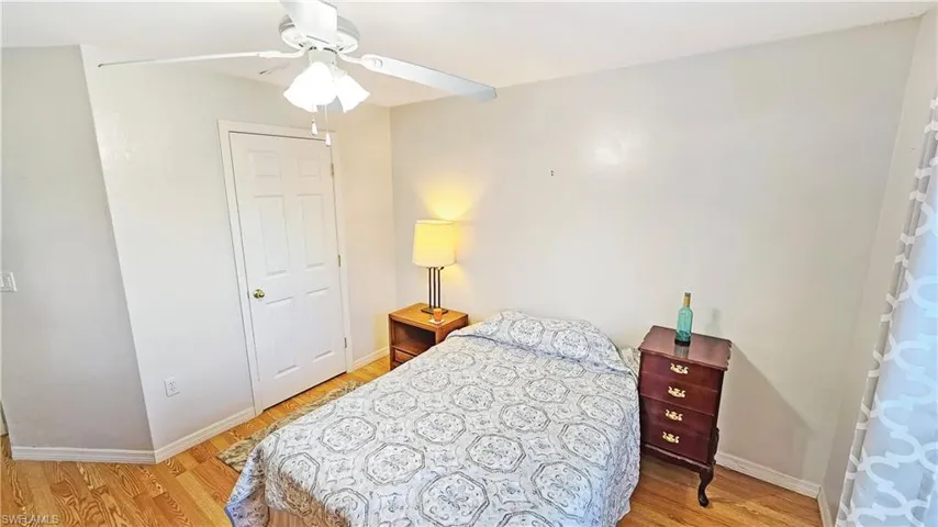 Bedroom with ceiling fan and light wood-type flooring